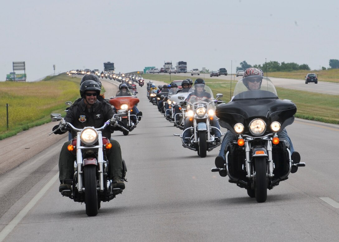 Col. Ty Neuman, 28th Bomb Wing vice commander, leads a pack of riders during the 2014 Dakota Thunder Motorcycle Run, Aug. 5, 2014. During the run, more than 150 motorcyclists rode in staggered formation to ensure a safe and enjoyable trip through the Black Hills. (U.S. Air Force photo by Senior Airman Anania Tekurio/Released)