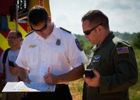 Karl Steinfelot, 96th Test Wing fire department, marks a checklist during a major accident response exercise Aug. 6 at Duke Field.  The simulated accident was a mid-air collision of a 33rd Fighter Wing joint strike fighter and a 919th Special Operations Wing C-145. Emergency responders from the base and the city were called to a downed aircraft scenario featuring fire, wreckage and victims with multiple injuries. The responders had to work as a team and coordinate movements at the simulated crash site, put out fires and attend to the wounded victims. (U.S. Air Force photo/Tech. Sgt. Jasmin Taylor)