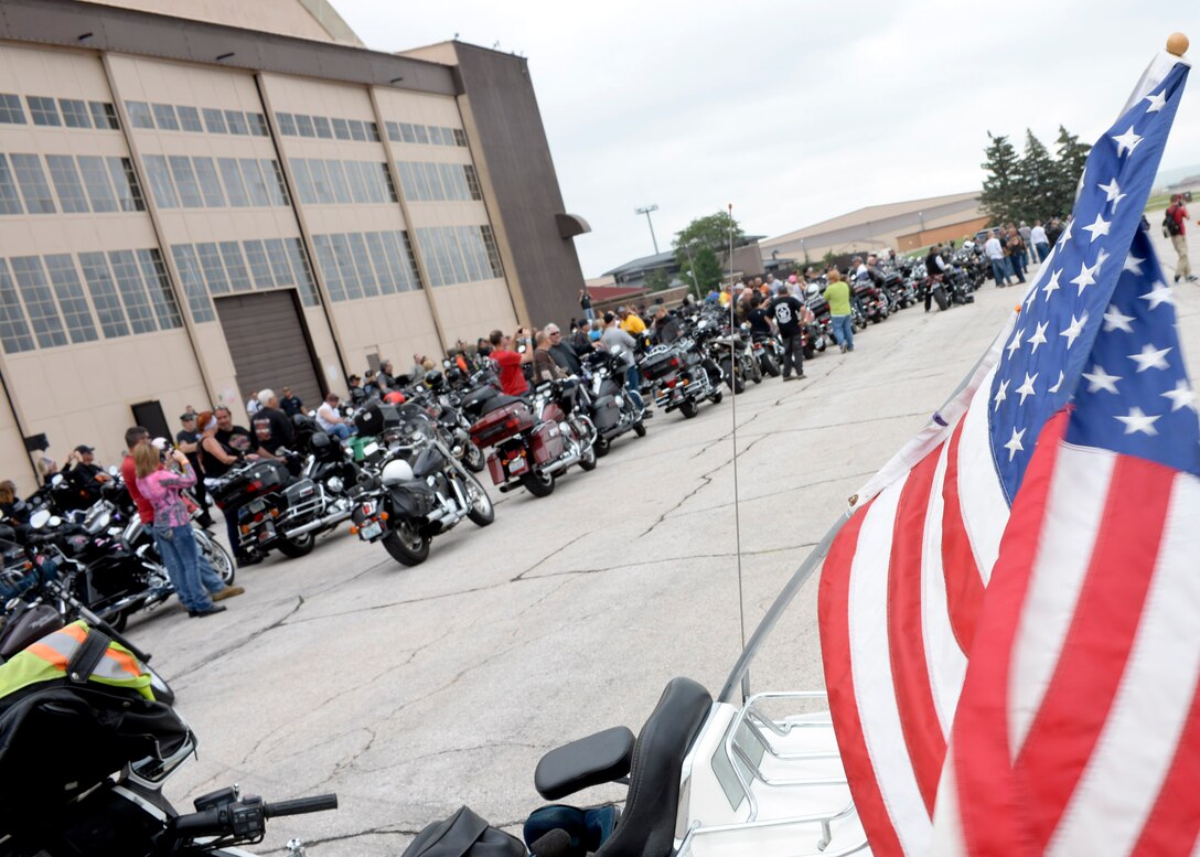 Airmen, family members and civilian motorcyclists gather on the flightline during the 2014 Dakota Thunder Motorcycle Run at Ellsworth Air Force Base, S.D., Aug. 5, 2014. Participants traveled from Ellsworth to Sturgis, S.D., and then attended a military appreciation ceremony recognizing local veterans, an annual event to honor military members, past and present. (U.S. Air Force photo by Senior Airman Anania Tekurio/Released)