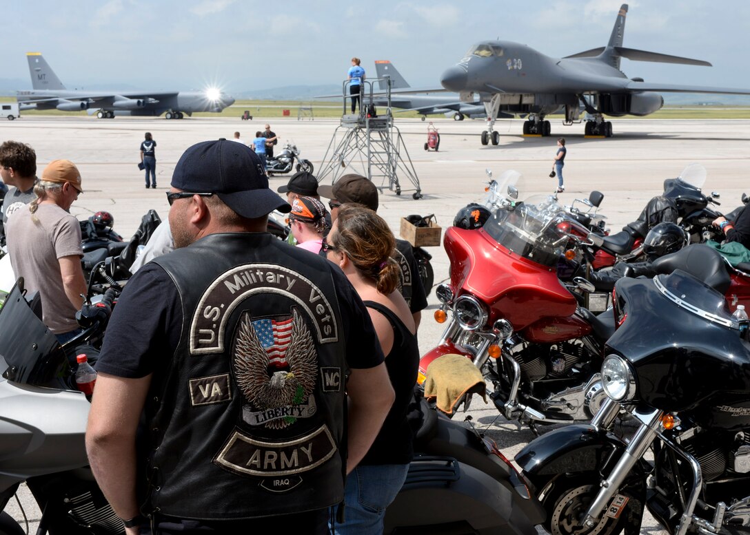 A group of more than 150 Airmen, family members and civilian motorcyclists gather on the flightline during the 2014 Dakota Thunder Motorcycle Run at Ellsworth Air Force Base, S.D., Aug. 5, 2014. The event, hosted by Ellsworth’s Green Knights Dakota Thunder Motorcycle Club, offered participants the opportunity to tour and photograph  a B-1 bomber and B-52 Stratofortress static displays before riding en masse to Sturgis, S.D. (U.S. Air Force photo by Senior Airman Anania Tekurio)