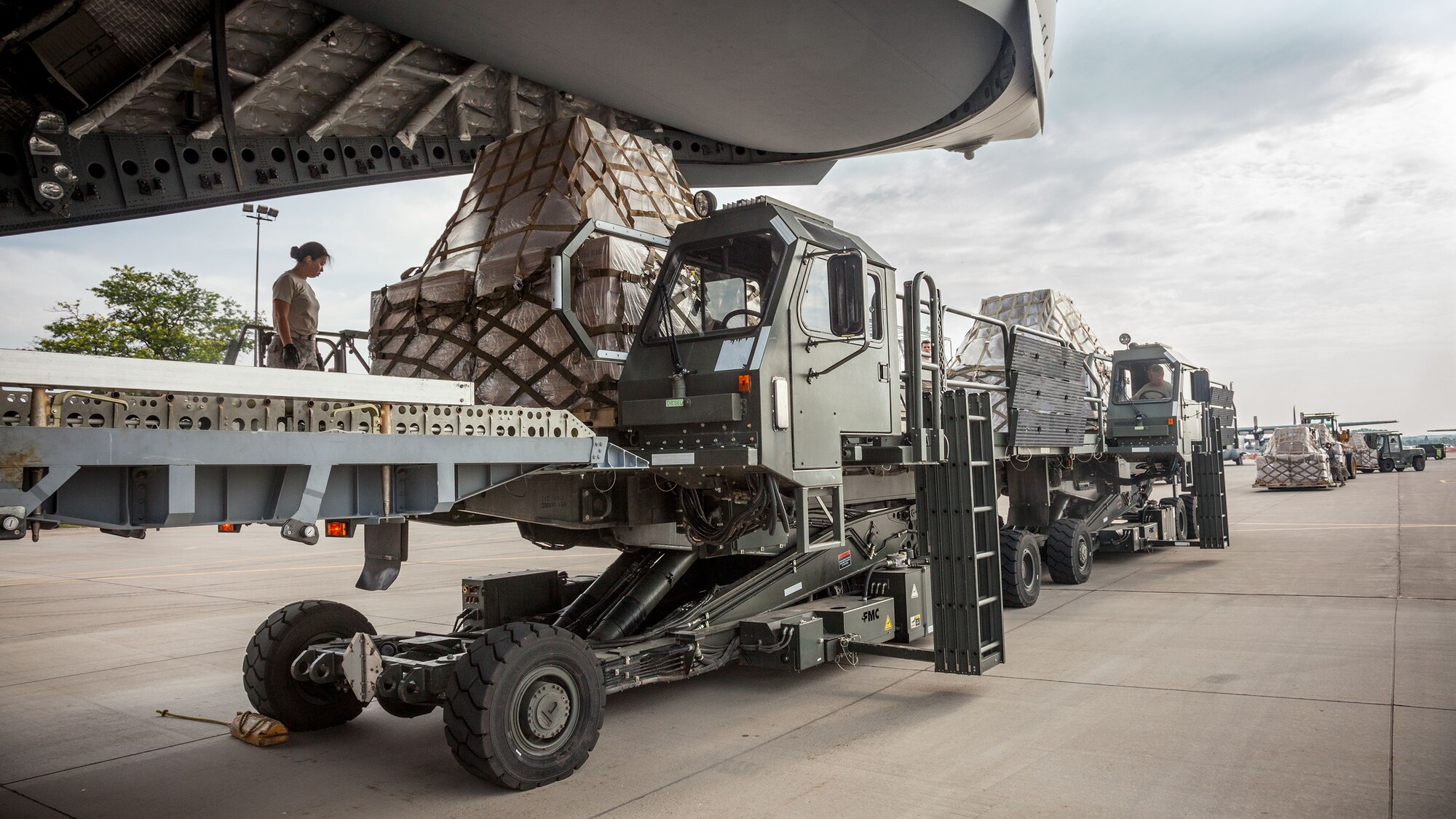 Airmen from the 27th Aerial Port Squadron load humanitarian aid pallets onto a C-17 Saturday morning at the Minneapolis-St. Paul Air Reserve Station, Minn.  The over 90,000 lbs of food from relief organization Food For Kidz will be sent to Kabul, Afghanistan, utilizing the Denton Program which allows donors to put humanitarian supplies aboard U.S. military transport on a space-available basis.  (U.S. Air Force photo/Shannon McKay)