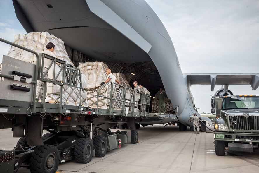 Airmen from the 27th Aerial Port Squadron load humanitarian aid pallets onto a C-17 Saturday morning at the Minneapolis-St. Paul Air Reserve Station, Minn.  The over 90,000 lbs of food from relief organization Food For Kidz will be sent to Kabul, Afghanistan, utilizing the Denton Program which allows donors to put humanitarian supplies aboard U.S. military transport on a space-available basis.  (U.S. Air Force photo/Shannon McKay)