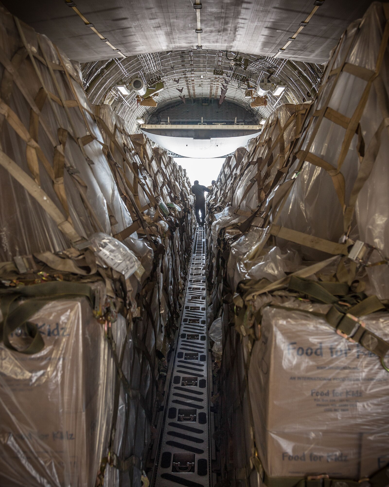 Airmen from the 27th Aerial Port Squadron load humanitarian aid pallets onto a C-17 Saturday morning at the Minneapolis-St. Paul Air Reserve Station, Minn.  The over 90,000 lbs of food from relief organization Food For Kidz will be sent to Kabul, Afghanistan, utilizing the Denton Program which allows donors to put humanitarian supplies aboard U.S. military transport on a space-available basis.  (U.S. Air Force photo/Shannon McKay)