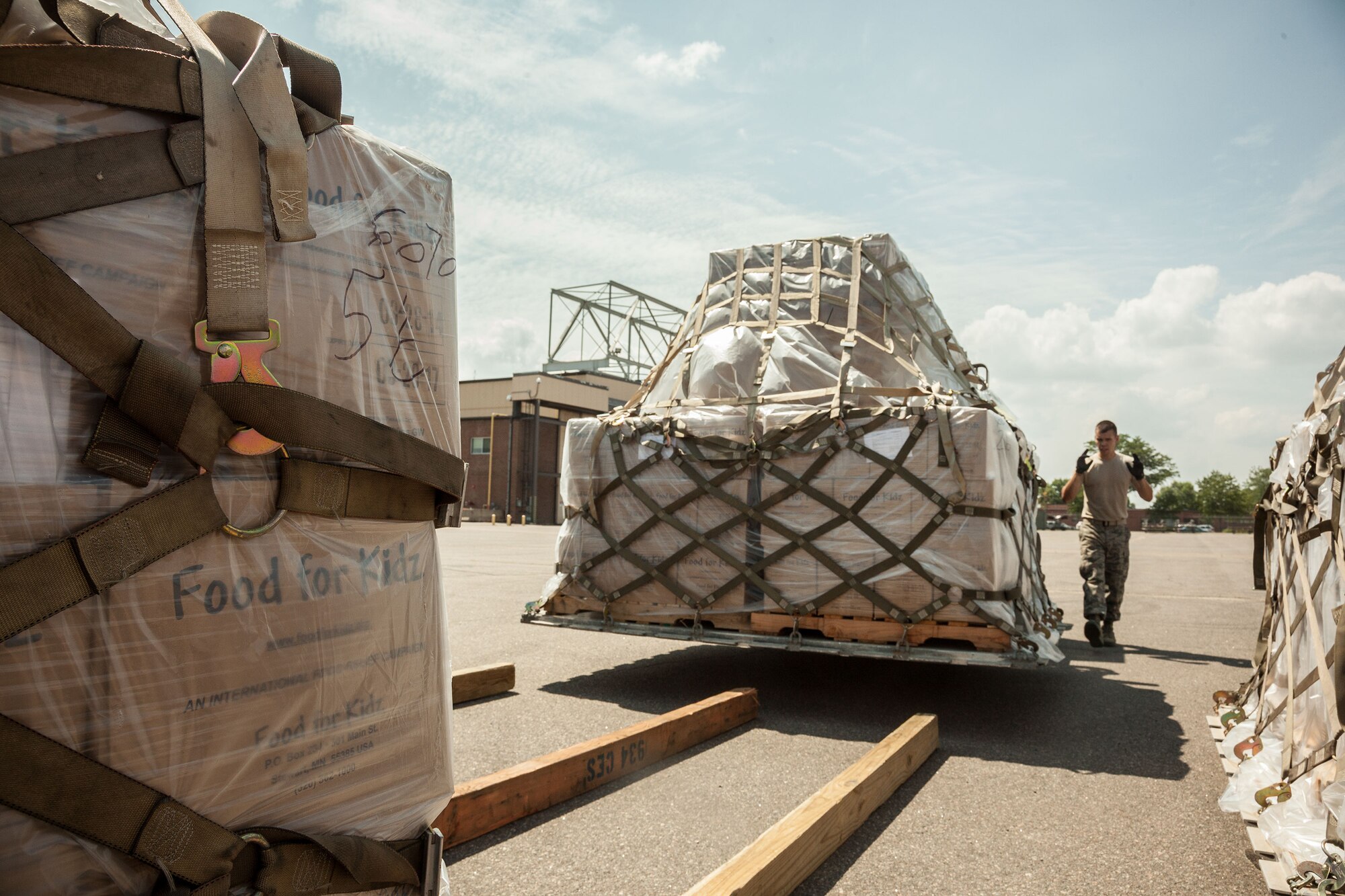 Airmen from the 27th Aerial Port Squadron work to stage humanitarian aid pallets for Saturday's shipment out of the Minneapolis-St. Paul Air Reserve Station, Minn.  The over 90,000 lbs of food from relief organization Food For Kidz will be sent to Kabul, Afghanistan, utilizing the Denton Program which allows donors to put humanitarian supplies aboard U.S. military transport on a space-available basis.  (U.S. Air Force photo/Shannon McKay)