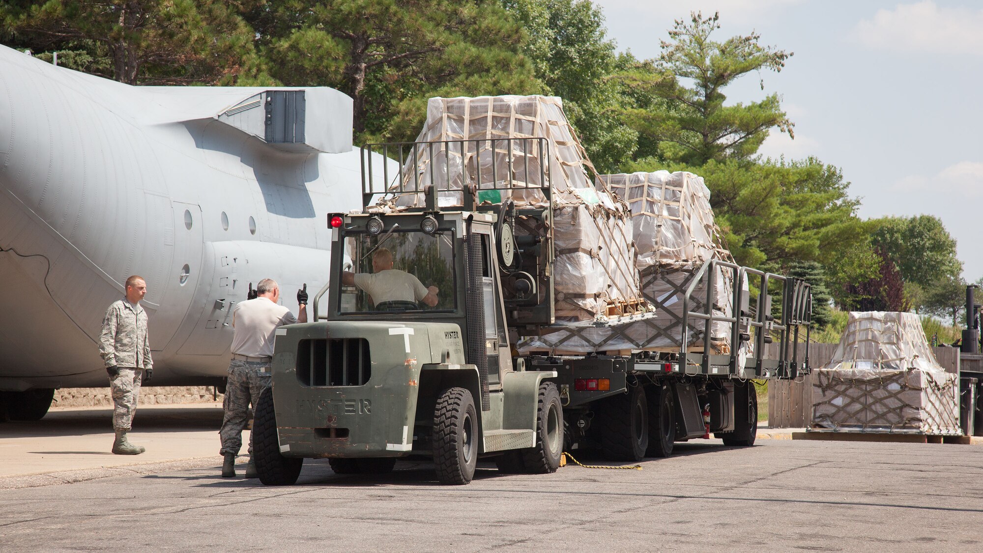 Airmen from the 27th Aerial Port Squadron work to stage humanitarian aid pallets for Saturday's shipment out of the Minneapolis-St. Paul Air Reserve Station, Minn.  The over 90,000 lbs of food from relief organization Food For Kidz will be sent to Kabul, Afghanistan, utilizing the Denton Program which allows donors to put humanitarian supplies aboard U.S. military transport on a space-available basis.  (U.S. Air Force photo/Shannon McKay)