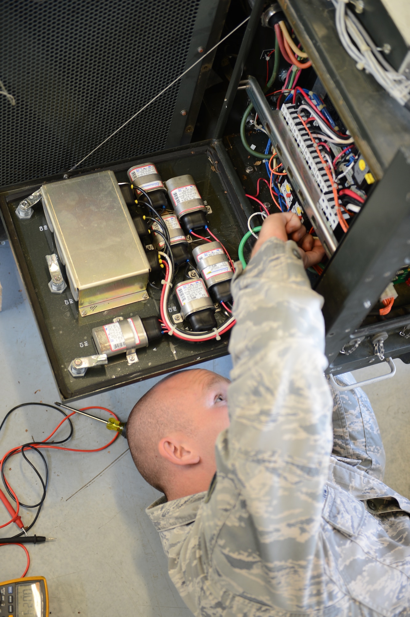 Staff Sgt. Larry Hampp, 435th Construction and Training Squadron heating ventilation air condition instructor, works on a field-deployable, environmental-control unit during a seven-day heating, ventilation and air conditioning course on Ramstein Air Base, Germany, Aug. 6, 2014. The FDECU is used to control the temperature of the facilities in deployed locations and costs around $10, 800. (U.S. Air Force photo/Airman 1st Class Michael Stuart)