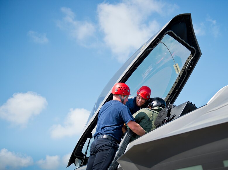 Eglin Air Force Base firefighters remove an unconscious pilot from an F-35A Lightning II during a joint-base major accident exercise between Eglin Air Force Base and Duke Field, Fla., Aug. 6.  The simulated accident was a mid-air collision of a 33rd Fighter Wing joint strike fighter and a 919th Special Operations Wing C-145.  First responders had to react to both accidents simultaneously, secure the scene, put out fires and help the wounded.  (U.S. Air Force photo/Tech. Sgt. Samuel King Jr.)