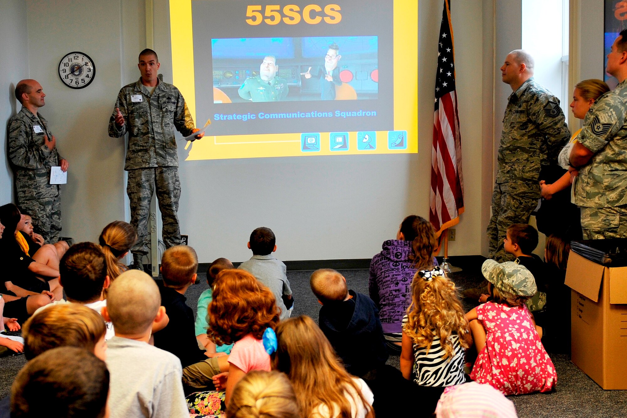 U.S. Air Force Master Sgt, Jason Morce, 55th Strategic Communication Squadron, speaks to children on the rules of engagement at the 55th Communications Group building Aug. 7 as part of the Bring Your Child to Work event. Children asked questions and were given a small brief on proper conduct before entering sensitive office spaces. (U.S. Air Force photo by Jeff W. Gates/Released)