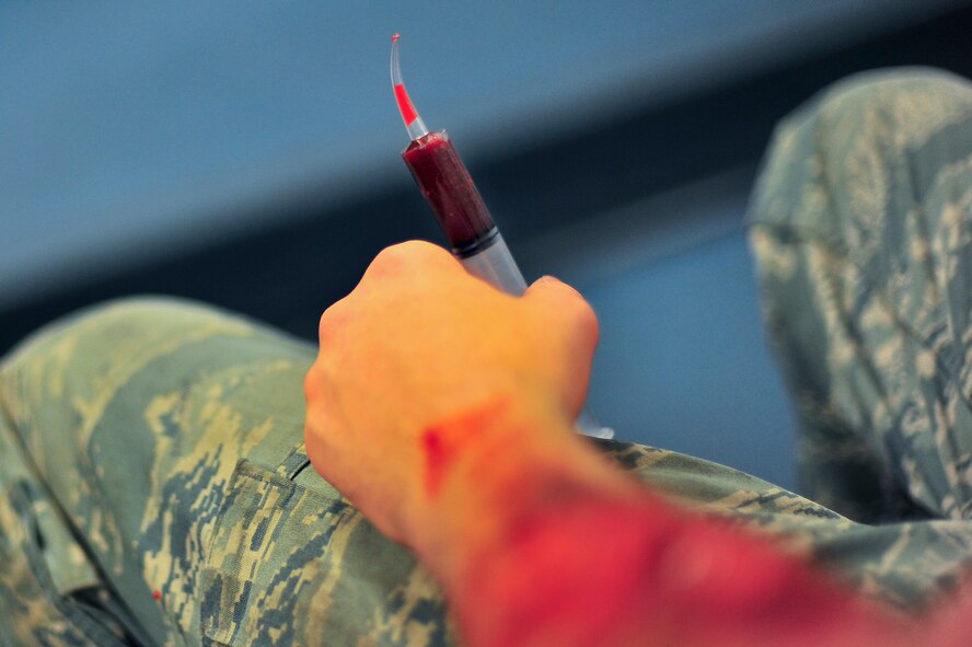 The moulage team from the 5th Medical Group applies makeup to simulated victims participating in an exercise on Minot Air Force Base, N.D., Aug. 5, 2014. The exercise focused on the base’s ability to respond, survive and operate in a chemical, biological, radiological or nuclear contaminated environment. (U.S. Air Force photo/Senior Airman Brittany Y. Bateman)