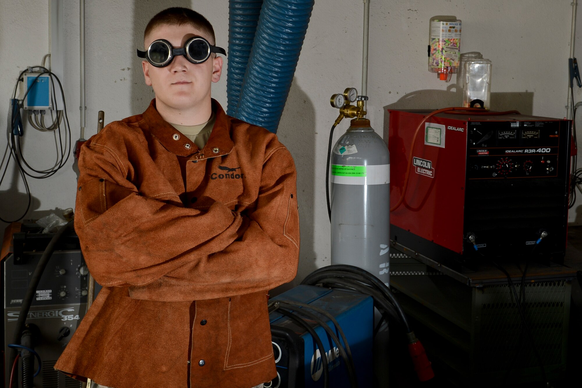 Airman First Class Brandon Slagle, 786th Civil Engineer Squadron structural journeyman, stands in front of welding equipment on Ramstein Air Base, Germany, Aug. 6, 2014. The 786th CES builds and maintains structures and utilities on and off Ramstein. (U.S. Air Force photo/Airman 1st Class Michael Stuart)