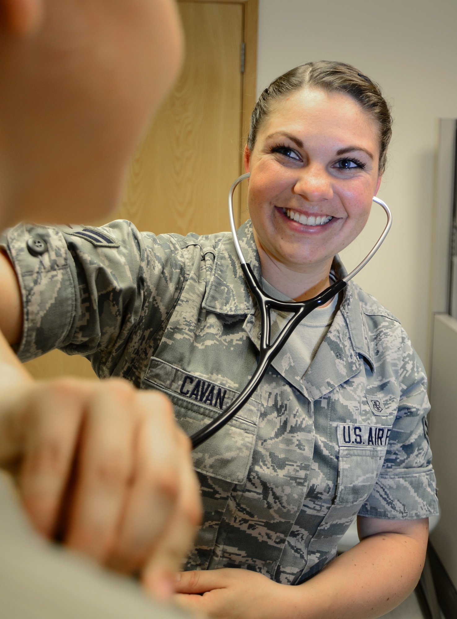 Airman 1st Class Stevie Cavan, 48th Medical Operations Squadron medical technician, examines a patient at the Royal Air Force Lakenheath, England hospital, Aug. 7, 2014. Cavan was nominated for a Liberty Spotlight because she displays the core value of Integrity First. (U.S. Air Force photo by Airman 1st Class Dawn M. Weber/Released)