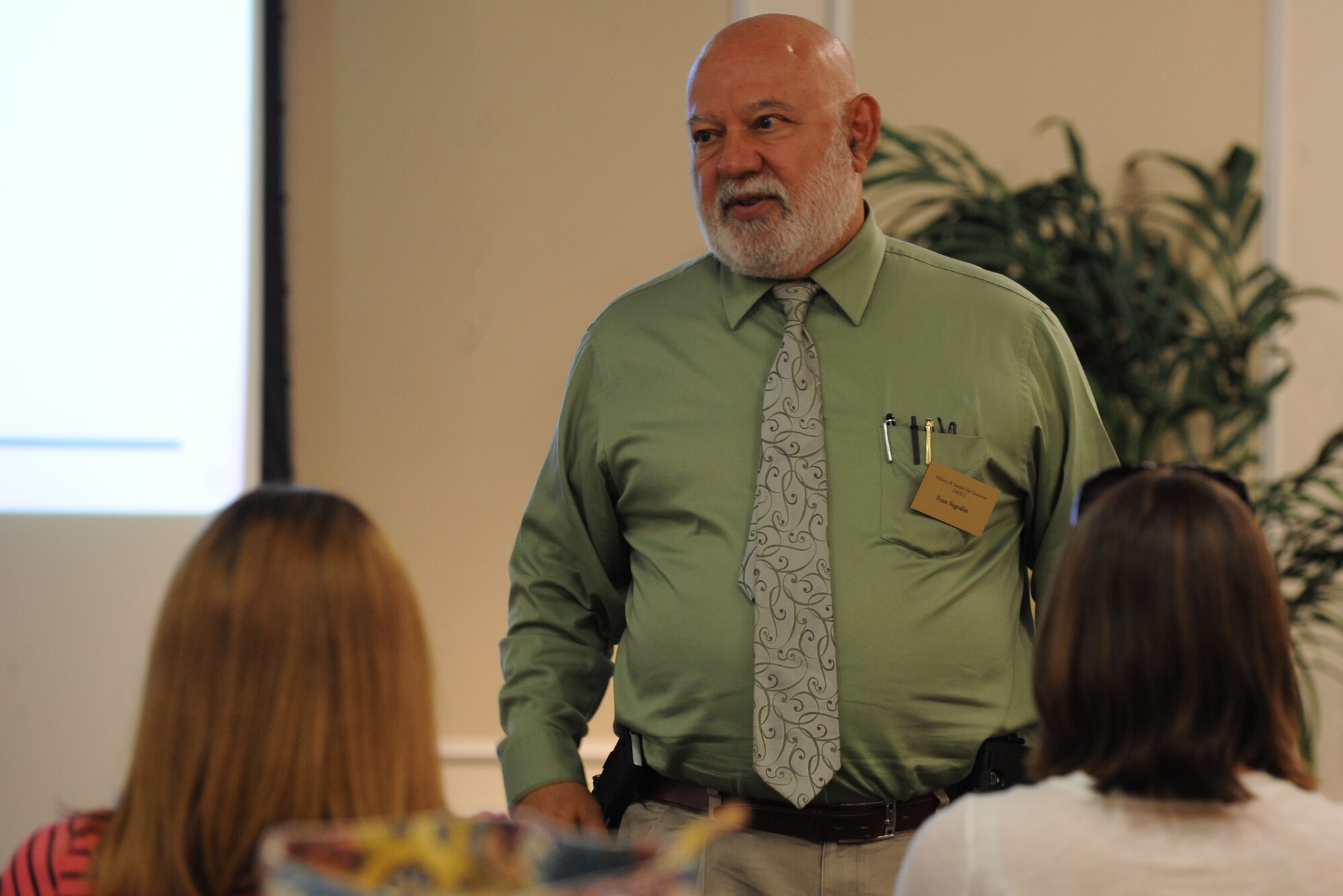 Francis Segedin, Military & Family Life counselor, addresses 20th Aircraft Maintenance Squadron spouses about the services they provide at Shaw Air Force Base, S.C., Aug. 5, 2014. The spouses were also briefed by a representative from the American Red Cross, Airmen and Family Readiness Center, and the 20th AMXS commander. (U.S. Air Force photo by Airman 1st Class Michael Cossaboom/Released)