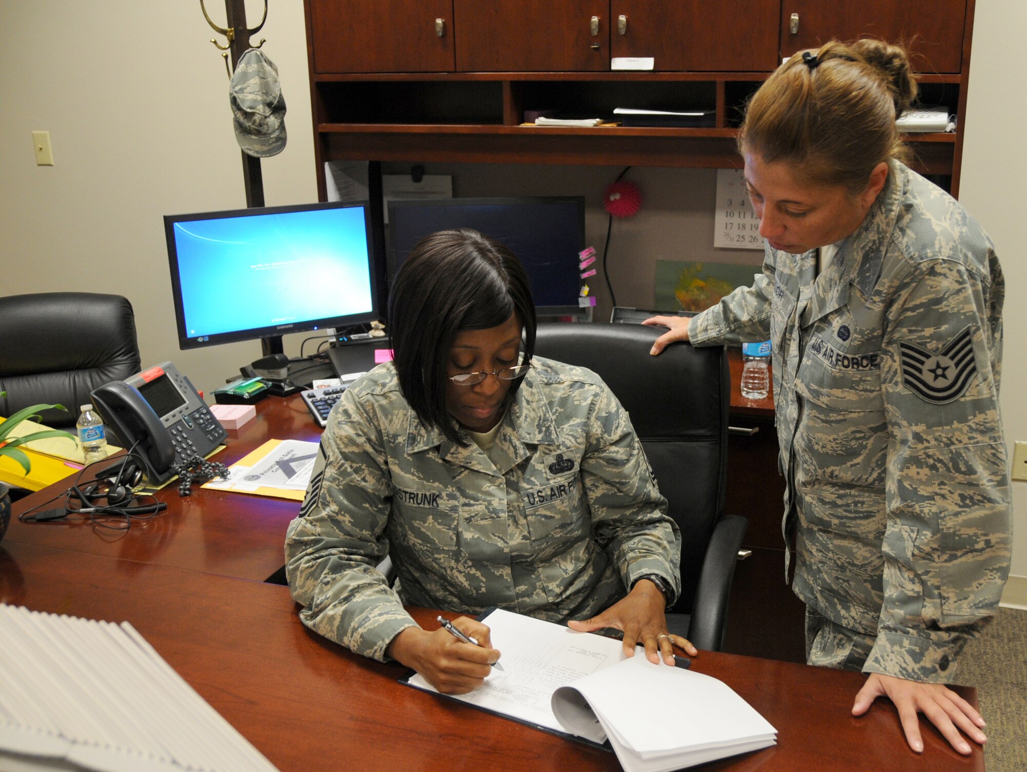 U.S. Air Force Master Sgt. Lakeisha Sistrunk (left), NCOIC of the Commanders Executive Support Staff, updates the Wing Unit Training Assembly schedule over drill weekend. Sistrunk provides administrative support to the fighter wing staff and Wing Commander. Some of her responsibilities include knowledge operations management, processing military orders, roll call and seamless customer service to the fighter wing. Additionally, she serves as one of two primary liaisons for the Commander ensuring communications and active requirements are distributed to leadership; guaranteeing minimal disruption to the overall operations of the wing. (U.S. Air National Guard photo by Capt. Craig Carper/Released)
