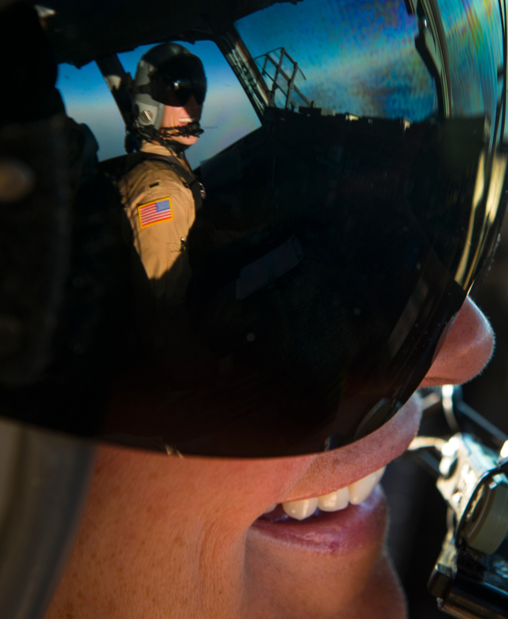 Capt. Erica Stooksbury, 816th Expeditionary Airlift Squadron, C-17 Globemaster III pilot, talks with her co-pilot 1st Lt. Mark Benischek, during a  humanitarian airdrop mission over Iraq, Aug. 9, 2014. The humanitarian aid includes bottled water and food which was delivered to displaced citizens in the vicinity of Sinjar, Iraq. (U.S. Air Force photo by Staff Sgt. Vernon Young Jr.)
