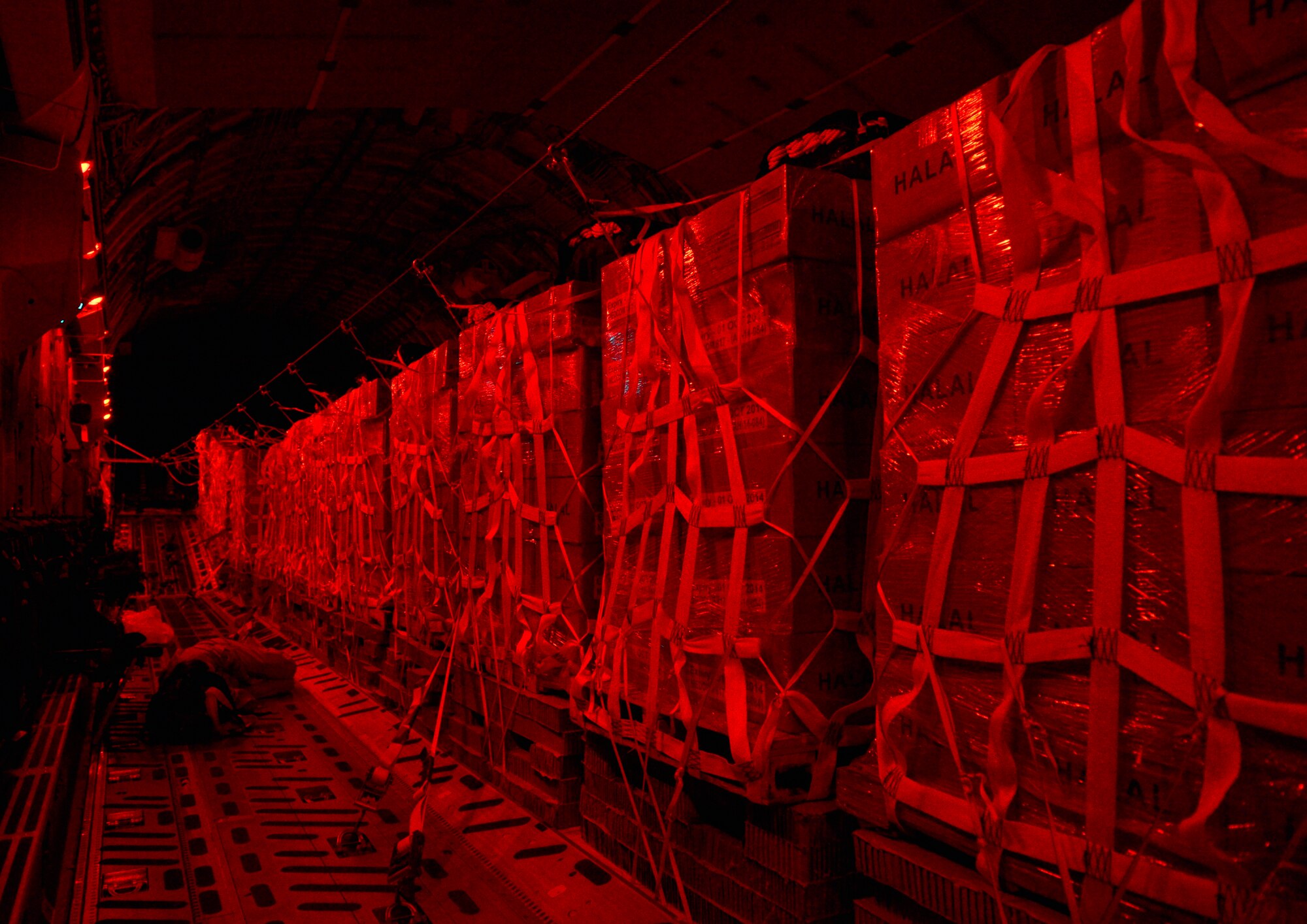 Bundles of halal meals sit aboard a C-17 Globemaster III for a humanitarian airdrop mission over Iraq, Aug. 9, 2014, at a base in the U.S. Central Command area of responsibility. The humanitarian aid includes bottled water and food which was delivered to displaced citizens in the vicinity of Sinjar, Iraq. (U.S. Air Force photo by Staff Sgt. Vernon Young Jr.)