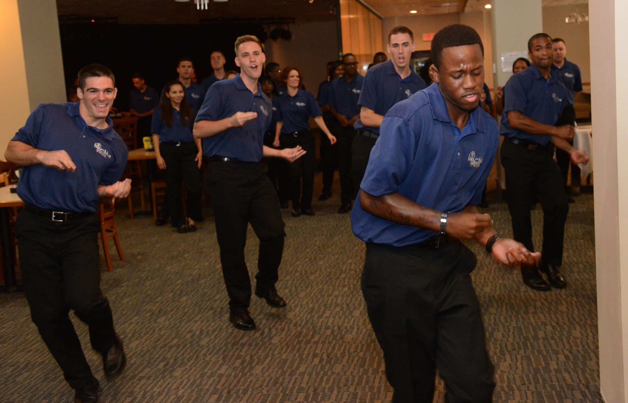 Senior Airman Jeffrey Ellis, Tops in Blue vocalist performs at the . Their performance featured all types of music along with precision choreography. The Tops in Blue crew spent the day putting on shortened performances at the dining facility, the Exchange and the Youth Center in addition to their main show performed for the whole base the prior evening as part of their 2014 “Celebrating 60 Years of Tradition” tour. (U.S. Air Force photo by Airman First Class Airman Adarius Petty)