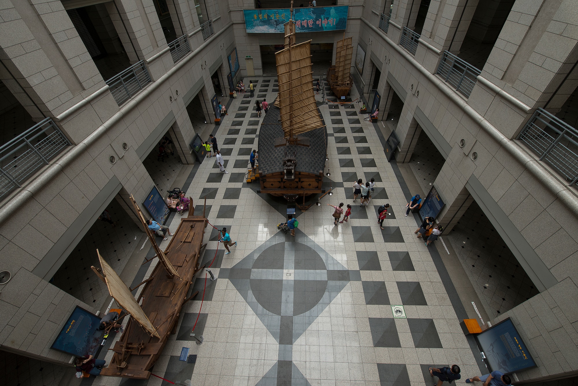 People puruse old warships at the War Memorial of Korea Aug. 2, 2014, in Seoul, Republic of Korea. The museum has replica ships and old model castles dating as far back as 500 B.C., when the peninsula was comprised of three perpetually-warring nations: Goguryeo, Baekje and Silla. (U.S. Air Force photo by Staff Sgt. Jake Barreiro)
