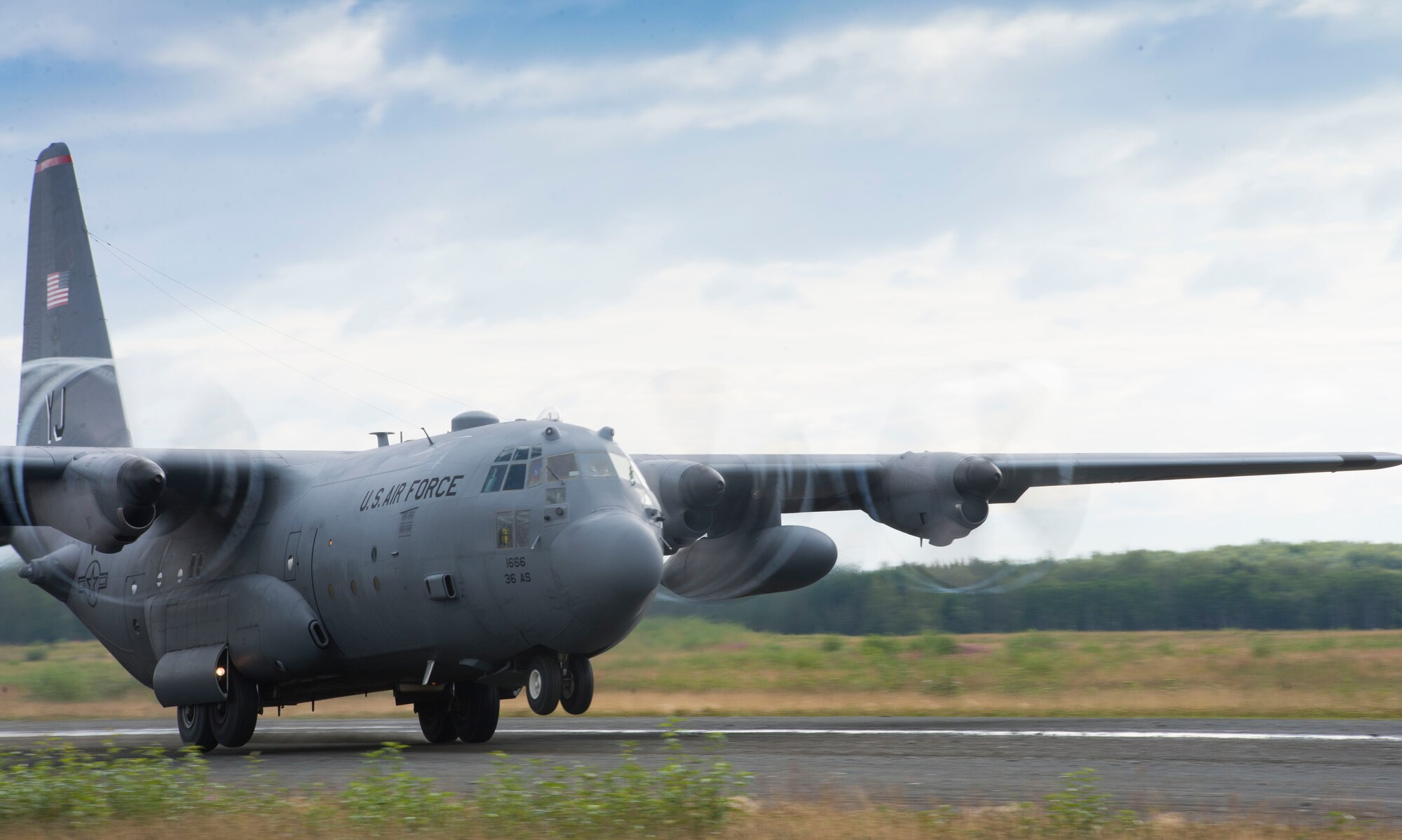 A C-130 Hercules from the 36th Airlift Squadron takes off from a secondary landing zone on Joint Base Elmendorf-Richardson, Alaska, Aug. 5, 2014. The C-130 made performed multiple takeoffs and landings as well as cargo drops. (U.S. Air Force photo by Staff Sgt. Chad C. Strohmeyer/Released)