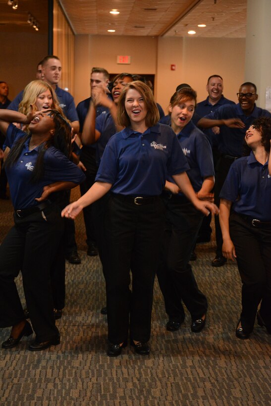 Senior Airman Jessica Seaborne, Tops in Blue  vocalist, performs at the Their performance featured all types of music along with precision choreography. Tops in Blue, the Air Force’s premier entertainment showcase, tours Air Force installations around the world to perform for Airmen and their families.  (U.S. Air Force photo by Airman First Class Airman Adarius Petty)