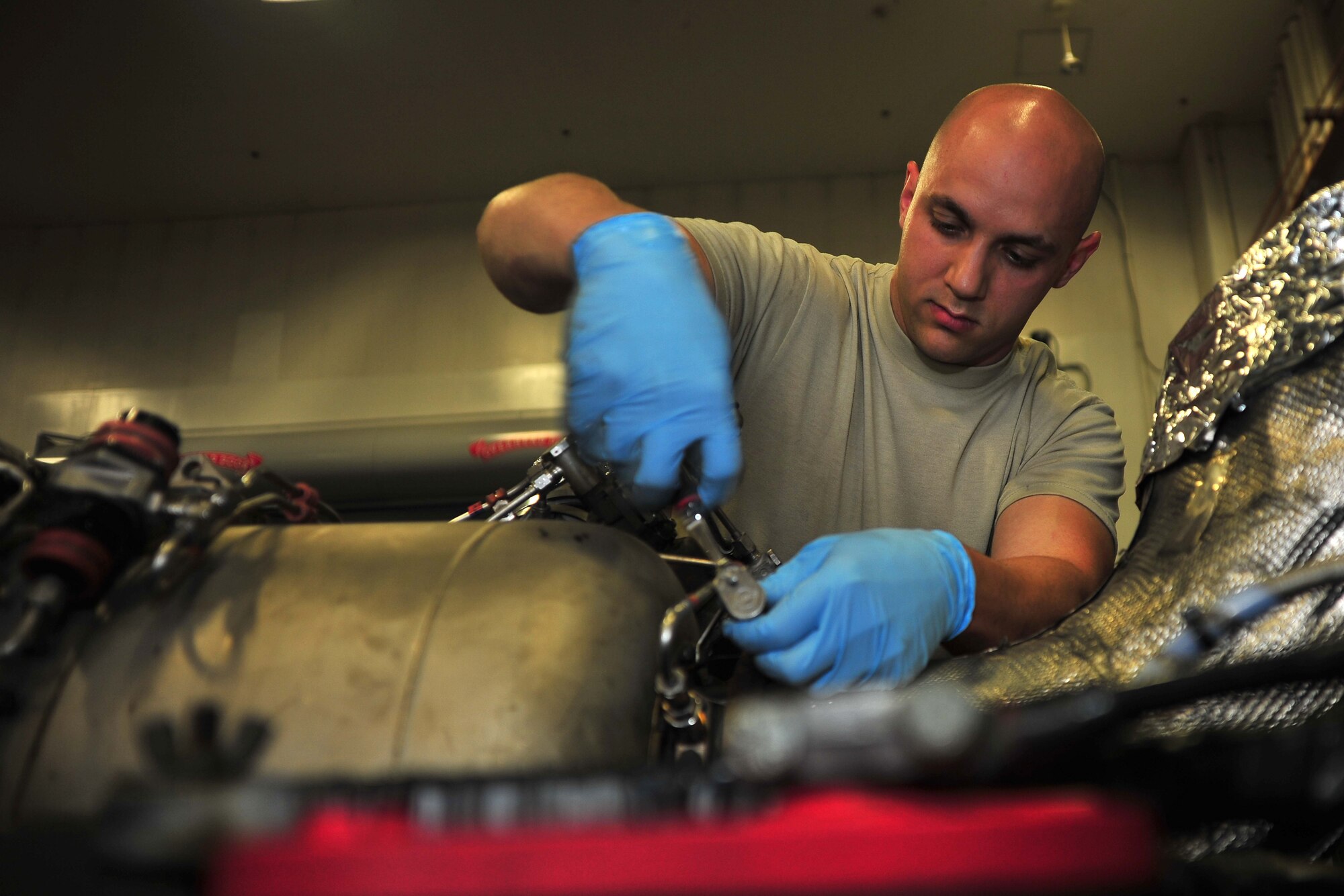 U.S. Air Force Staff Sgt. Devon Brown, 35th Maintenance Squadron aerospace ground equipment craftsman, removes bolts on a gas turbine generator at Misawa Air Base, Japan, Aug. 7, 2014. Brown supports 44 F-16CM Fighting Falcon aircraft by inspecting, repairing, and servicing 500 pieces of aerospace ground equipment. (U.S. Air Force photo/Senior Airman Jose L. Hernandez-Domitilo)