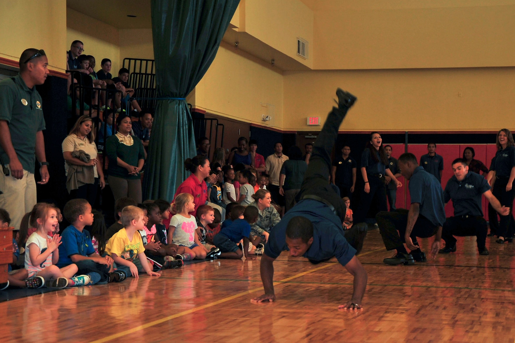 Tops in Blue members perform a song and dance for children at the Youth Center on Andersen Air Force Base, Guam, Aug. 7, 2014. Tops in Blue, the Air Force’s premier entertainment showcase, tours Air Force installations around the world to perform for Airmen and their families. (U.S. Air Force photo by Staff Sgt. Melissa B. White/Released)