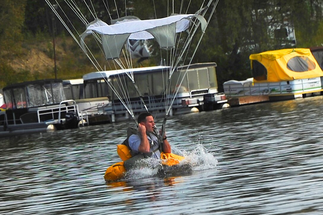 A paratrooper using a T-11 parachute makes a water landing in Big Lake, Alaska, Aug. 6, 2014.