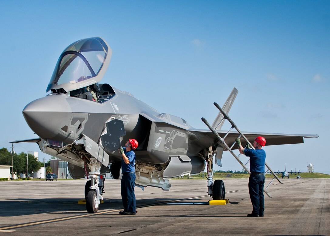 Dan Bye, a firefighter with the 96th Test Wing, opens the canopy of an F-35A Lightning II to gain access to an unconscious pilot during a joint-base major accident response exercise between Eglin Air Force Base and Duke Field, Fla., Aug. 6.  The simulated accident was a mid-air collision of a 33rd Fighter Wing joint strike fighter and a 919th Special Operations Wing C-145.  First responders had to react to both accidents simultaneously, secure the scene, put out fires and help the wounded.  (U.S. Air Force photo/Tech. Sgt. Samuel King Jr.)