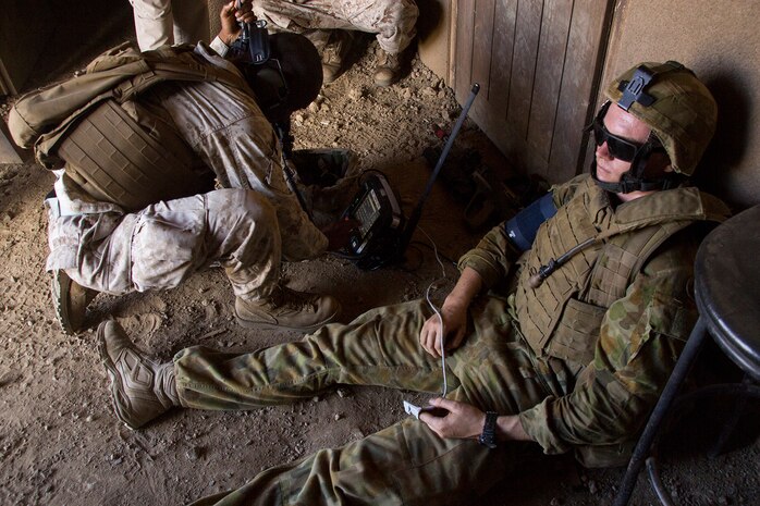 MARINE CORPS TRAINING AREA BELLOWS, Hawaii – A U.S. Navy corpsman diagnoses an injured Australian Defence Force soldier who simulated wounds during a raid on a military operations in urban terrain facility at Marine Corps Training Area Bellows, July 12, during Rim of the Pacific (RIMPAC) Exercise 2014. The corpsman used the Tactical Tele-Medicine (TTM) machine to assess the soldier’s condition and relayed information back to the command operations center. The TTM is part of the Marine Corps Advanced Warfighting Experiment, a culmination of progressive experiments designed to test potential future technologies, solutions and concepts to future Marine Air Ground Task Force challenges. (U.S. Marine Corps photo by Cpl. Matthew J. Bragg)