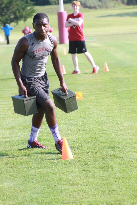 A player with Ardmore High School football team, conducts the maneuver under fire portion of the Combat Fitness Test at Ardmore High School, OK, Aug. 4, 2014.The CFT is designed to be a functional combat fitness training for deployed Marines. (U.S. Marine Corps photo by Sgt. Alfredo V. Ferrer)