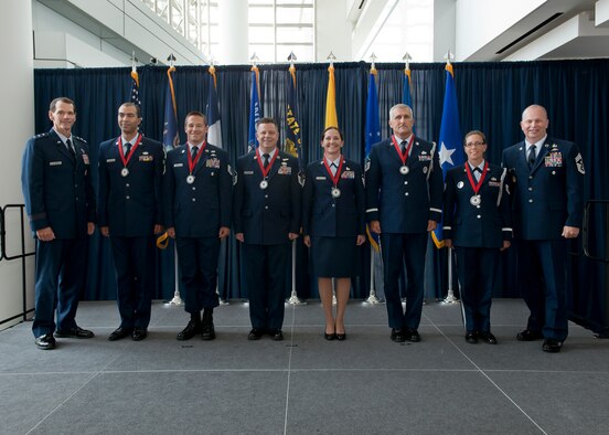 Lt. Gen. Stanley E. Clarke III, director of the Air National Guard (left) and Chief Master Sgt. James W. Hotaling, the command chief master sergeant of the ANG (far right), stand with the ANG Outstanding Airmen of the Year during an All Call event at Joint Base Andrews, Maryland August 7, 2014. The OAY winners are (left to right) Senior Airman. Christian Goldsmith, Airman of the Year, Technical Sgt. Doug Matthews, Non-Commissioned Officer of the Year, Master Sgt. Joseph G. Ashwood, Senior Non-Commissioned Officer of the Year, Master Sgt. Linda Schwartzlow, First Sergeant of the Year, Master Sgt. David Coker, Honor Guard Program Manager of the Year, and Technical Sgt. Amy Ough, Honor Guard Member of the Year. (Air National Guard photo by Master. Sgt. Marvin R. Preston)