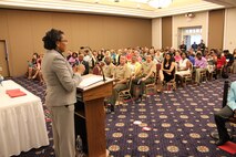 Graduates, family members and base leadership listens to Melora McVicker, Melora McVicker, education services officer at the Voluntary Education Center, speak during the Voluntary Education Center’s graduation celebration at the Clubs at Quantico on July 24.