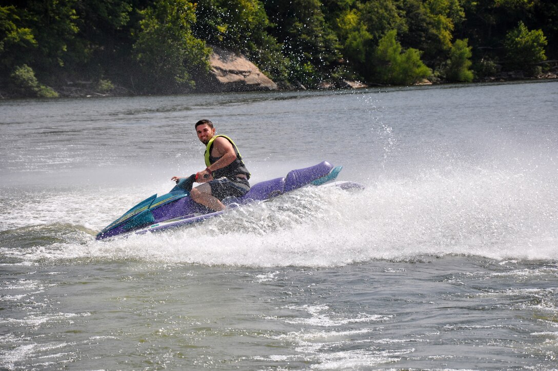 JD Tucker, Rough River Lake park ranger, rides a jet ski during filming of water safety videos at the lake July 30, 2014. Tucker worked as part of the team to show the importance of wearing a life jacket.