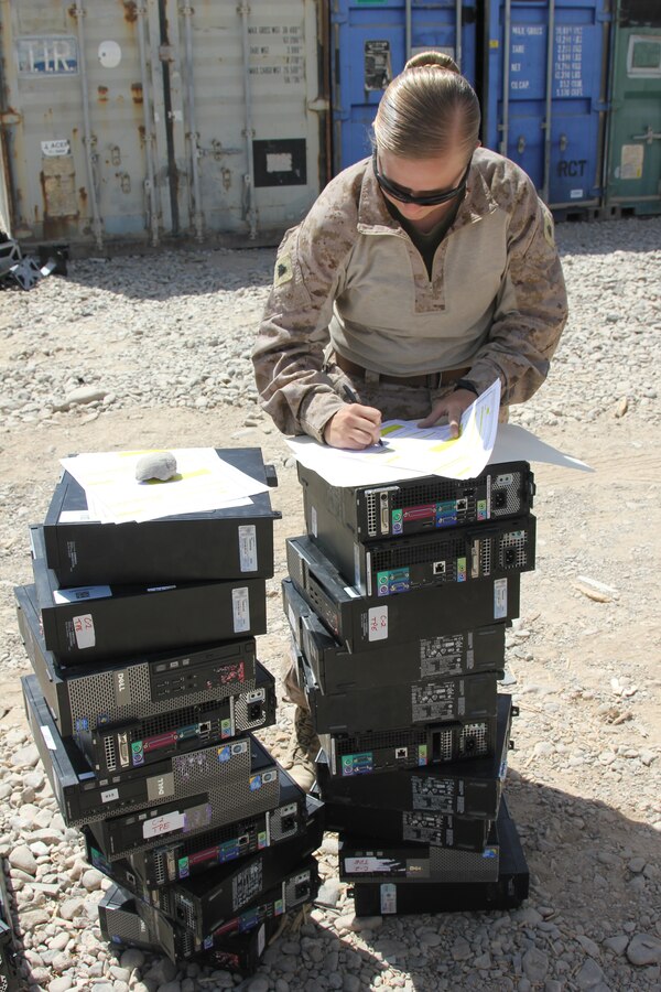 Sergeant Andrea M. Robb, the Theater Provided Equipment clerk with Marine Expeditionary Brigade - Afghanistan, fills out the proper paperwork after receiving computer equipment from a unit with Regional Command (Southwest) as part of the retrograding efforts. Robb is responsible for a $28 million account and oversees approximately 8,500 pieces of equipment needing to be retrograded back to the States.