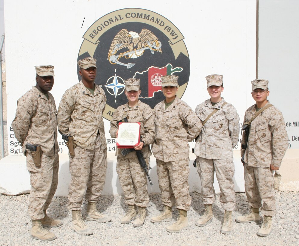Sergeant Andrea M. Robb, the Theater Provided Equipment clerk with Marine Expeditionary Brigade - Afghanistan, poses for a picture with the MEB-A supply section following her meritorious promotion to sergeant aboard Camp Leatherneck, Helmand province, Afghanistan, Aug. 2, 2014. Robb is responsible for a $28 million account, and oversees approximately 8,500 pieces of equipment needing to be retrograded back to the States. This is Robb’s third meritorious promotion since joining the Marine Corps approximately three years ago.