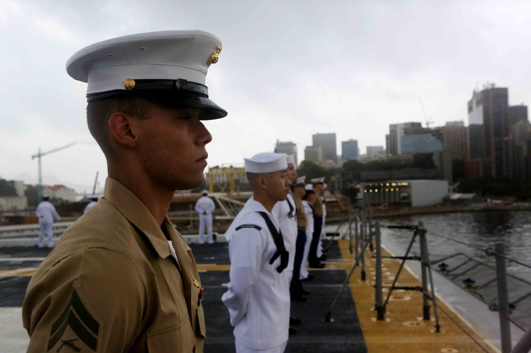 Marines and sailors with Special Purpose Marine Air Ground Task Force South man the rails on the flight deck of the future amphibious assault ship USS America (LHA 6) in Rio De Janeiro, Brazil, Aug. 5, 2014. The ship will invite multiple guests from Brazil for tours and a formal reception, while Marines and Sailors of SPMAGTF-South participates in bi-lateral theater security cooperation activities with the Brazilian military. Bi-lateral activities with our partners strengthen the relationships that facilitate the cooperation needed in the event of a crisis requiring a multinational effort. SPMAGTF-South is currently embarked aboard America on her maiden transit, “America Visits the Americas”. The ship is scheduled to be commissioned in San Francisco, Oct. 11. (U.S. Marine Corps photo by Cpl. Christopher J. Moore/Released)