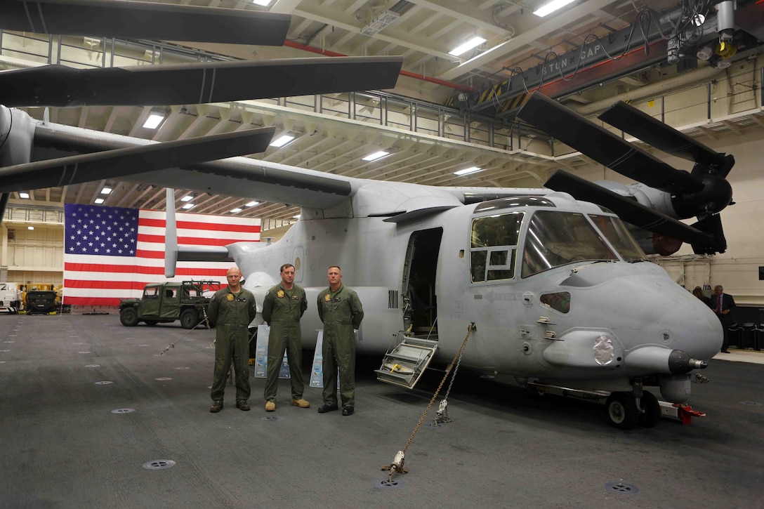 Marines with Marine Operational Test and Evaluation Squadron 22 (XVM-22) stand at a static display of the MV-22 Osprey during a reception in the hangar bay of the future amphibious assault ship USS America (LHA 6) at Rio De Janeiro, Brazil, Aug. 7, 2014. The Marines answered questions about the MV-22 and gave guests the opportunity to walk inside the aircraft. The reception was hosted by the Sailors and Marines of USS America and Special Purpose Marine Air Ground Task Force South for Brazilian diplomats and military officials. The evening of food, music and dancing concluded with speeches from Rear Adm. Frank L. Ponds, commander of Expeditionary Strike Group 3 and The Honorable Liliana Ayalde, U.S. Ambassador to Brazil. America is currently on her maiden transit, “America Visits the Americas”. The transit is a clear example of our Nation’s commitment to our regional partners and allies, demonstrating the Navy-Marine Corps integration in action. (U.S. Marine Corps photo by 1st Lt. Joshua Pena/Released)