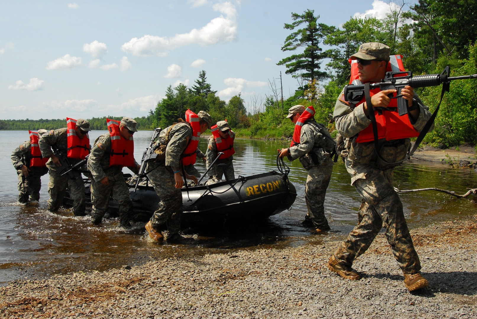 New York Army National Guard Soldiers of C Troop 2nd Squadron 101st Cavalry hit the shore of Indian Lake after crossing it in Zodiac inflatable boats during an annual training exercise Aug. 10, 2014. 