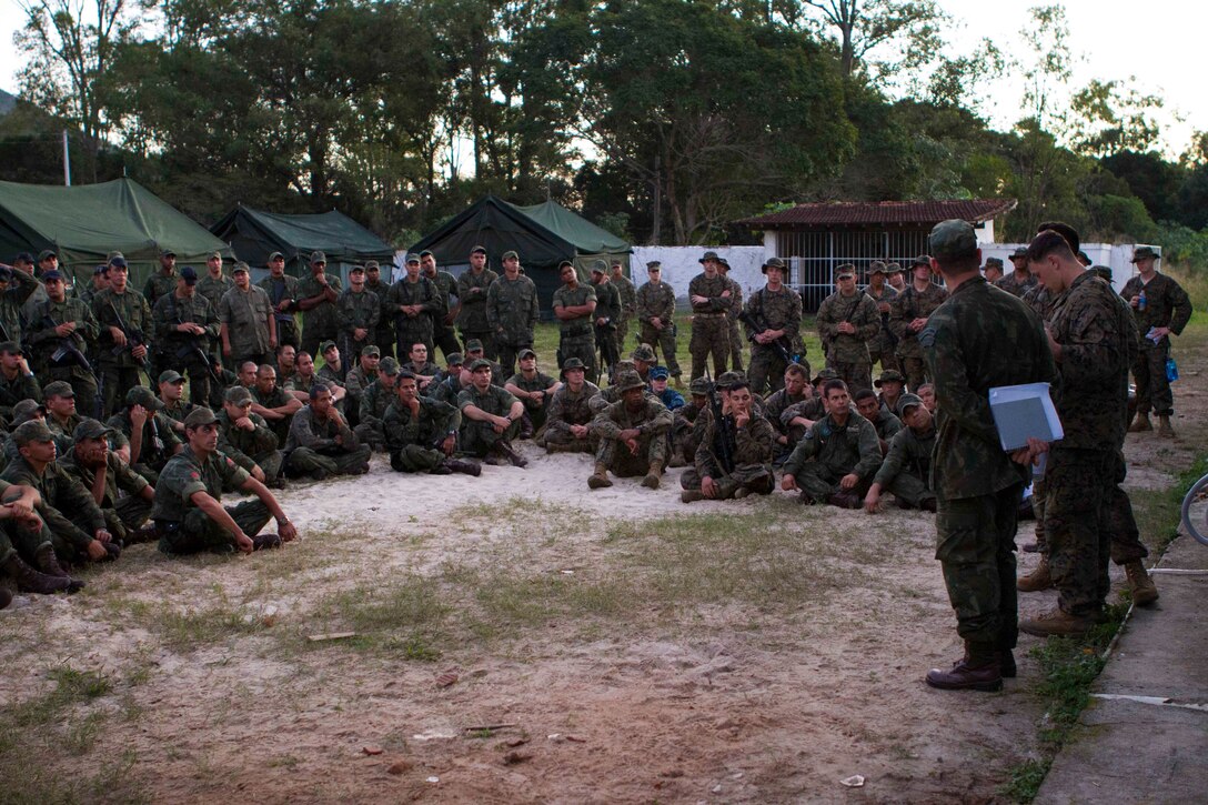 U.S. Marines with Special Purpose Marine Air Ground Task Force South share experiences of warfighting tactics with Brazilian Naval forces at Marambaia Island, Brazil, Aug. 4, 2014, as part of a theater security cooperation event. The TSC event was made up of multiple bi-lateral exchanges to include medical treatment, improvised explosive device detection, combat tracking and combat marksmanship. Through close cooperation, the U.S. and its partners are ready to address transnational security challenges through integrated and coordinated approaches. SPMAGTF-South is currently embarked aboard the future amphibious assault ship USS America (LHA 6) in support of her maiden transit, "America Visits the Americas." (U.S. Marine Corps Photo by Cpl. Donald Holbert/ Released)