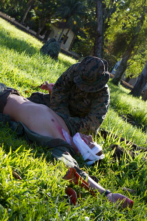 Petty Officer 2nd Class Gabriel Besa, U.S. Navy hospital corpsman with Special Purpose Marine Air Ground Task Force South, and a native of Pearland, Texas, provides emergency medical care to a simulated casualty during a bi-lateral medical exchange with Brazilian Naval forces at Marambaia Island, Brazil, Aug. 6, 2014. During the exchange, U.S. Marines and Sailors had the opportunity to share tactics from their Combat Lifesaver course as part of a theater security cooperation event with the Logistics Combat Element of SPMAGTF-South. Through close cooperation, the U.S. and its partners are ready to address transnational security challenges through integrated and coordinated approaches. SPMAGTF-South is currently embarked aboard the future amphibious assault ship USS America (LHA 6) in support of her maiden transit, "America Visits the Americas." (U.S. Marine Corps Photo by Cpl. Donald Holbert/ Released)