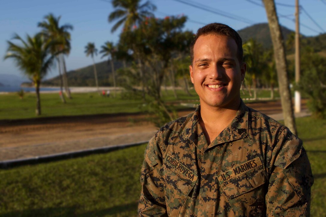 Corporal Christopher Cordero Vega, Logistics Combat Element combat engineer section head with Special Purpose Marine Air Ground Task Force South, and a native of Humacao, Puerto Rico, poses for a photo during a theater security cooperation event at Marambaia Island, Brazil, Aug. 6, 2014. Cordero Vega participated in the TSC event as an instructor for the counter improvised explosive device course held for U.S and Brazilian Marines. The counter IED course was conducted in conjunction with a combat tracking course as part of the bi-lateral exchange. Through close cooperation, the U.S. and its partners are ready to address transnational security challenges through integrated and coordinated approaches. SPMAGTF-South is currently embarked aboard the future amphibious assault ship USS America (LHA 6) in support of her maiden transit, "America Visits the Americas." (U.S. Marine Corps Photo by Cpl. Donald Holbert/ Released)