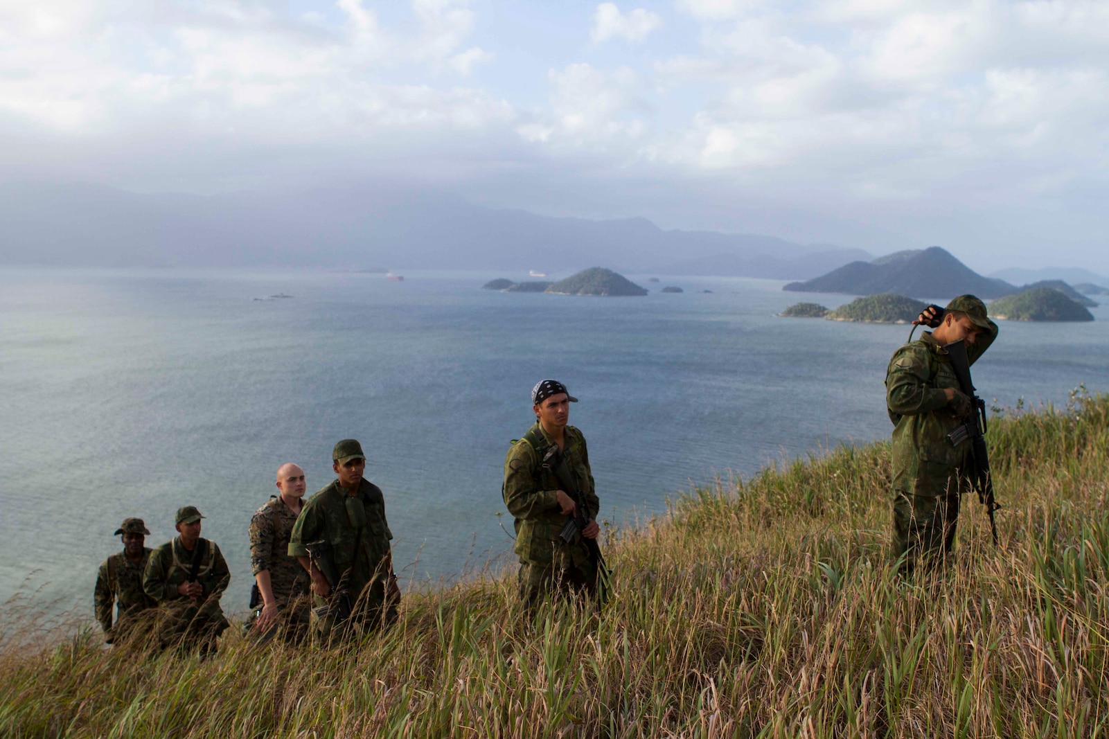 Brazilian Marines track a simulated enemy up a mountain during a bi-lateral combat tracking exchange held on Marambaia Island, Brazil, Aug. 5, 2014. During the exchange, Brazilian and U.S. Marines with Special Purpose Marine Air Ground Task Force South shared their tactics on tracking enemy personnel and how to spot hidden improvised explosive devices. Through close cooperation, the U.S. and its partners are ready to address transnational security challenges through integrated and coordinated approaches. SPMAGTF-South is currently embarked aboard the future amphibious assault ship USS America (LHA 6) in support of her maiden transit, "America visits the Americas." (U.S. Marine Corps Photo by Cpl. Donald Holbert/ Released)