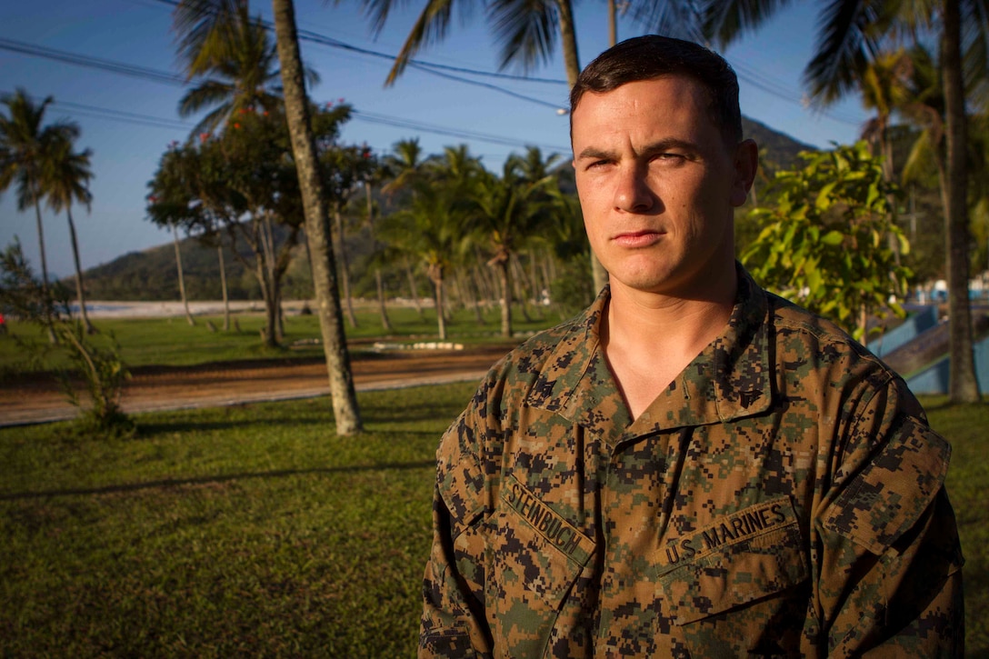Corporal Jake Steinbuch, Logistics Combat Element optics chief with Special Purpose Marine Air Ground Task Force South, and a native of Temecula, California, poses for a photo during a theatre security cooperation event on Marambaia Island, Brazil, Aug. 6, 2014. Steinbuch participated in the TSC event as an instructor for the combat tracking exchange held for U.S. and Brazilian Marines. During the exchange, Brazilian and U.S. Marines shared their tactics on tracking enemy personnel and how to spot hidden improvised explosive devices. Through close cooperation, the U.S. and its partners are ready to address transitional security challenges through integrated and coordinated approaches. SPMAGTF-South is currently embarked aboard the future amphibious assault ship USS America (LHA 6) in support of her maiden transit, "America visits the Americas." 