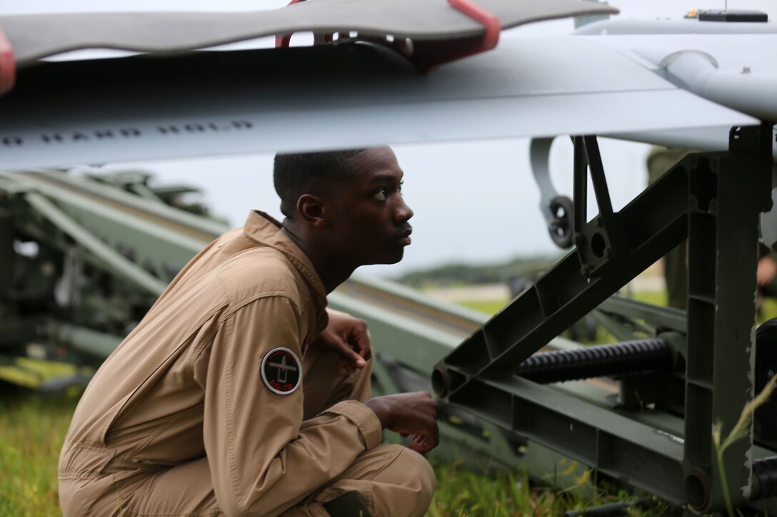 Cpl. Christopher Senn inspects an RQ-7B Shadow unmanned aerial vehicle and launching system as part of pre-flight inspections during training at Avon Park Air Force Range, Fla., Aug. 4, 2014. Senn is an unmanned aerial system operator with Marine Unmanned Aerial Vehicle Squadron 2 and native of Washington, D.C.