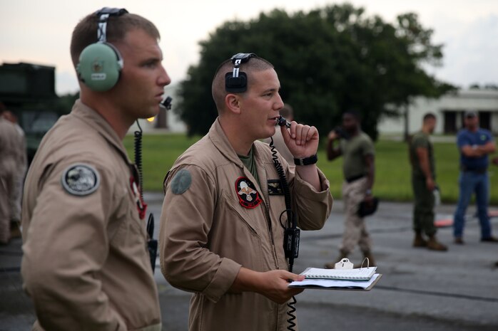 Capt. Guy R. Nelson, left, monitors Capt. Robert Burns during RQ-7B Shadow unmanned aerial vehicle training missions at Avon Park Air Force Range, Fla., Aug. 4, 2014. Nelson was monitoring Burns on his ability to command flights alone. Nelson is an unmanned aviation commander instructor and Burns is an unmanned aviation commander, both with Marine Unmanned Aerial Vehicle Squadron 2. Nelson is a native of Brookfield, Ill., and Burns is a Scranton, Pa., native.