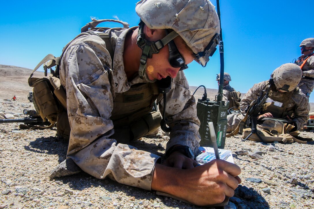 Lance Cpl. Michael T. Buhler from New York, N.Y., a forward observer with 1st Battalion, 1st Marine Regiment, 1st Marine Expeditionary Brigade, calls for fire support while conducting combined arms training in support of Large Scale Exercise 2014 aboard Marine Corps Air Ground Combat Center Twentynine Palms, Calif., Aug. 9. LSE-14 is a bilateral training exercise being conducted by 1st MEB to build U.S. and Canadian forces’ joint capabilities through live, simulated, and constructive military training activities from Aug. 8-14, 2014. (U.S. Marine Corps Photo by Cpl. Rick Hurtado/Released)