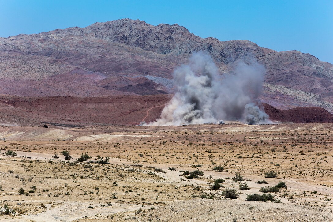 A series of impacts from artillery and air fire make up an explosion seen in the the distance as a result of combined arms trainining conducted by Marines of 1st Battalion, 1st Marine Regiment, 1st Marine Expeditionary Brigade in support of Large Scale Exercise 2014 aboard Marine Corps Air Ground Combat Center Twentynine Palms, Calif., Aug. 9. LSE-14 is a bilateral training exercise being conducted by 1st MEB to build U.S. and Canadian forces’ joint capabilities through live, simulated, and constructive military training activities from Aug. 8-14, 2014. (U.S. Marine Corps Photo by Cpl. Rick Hurtado/Released)