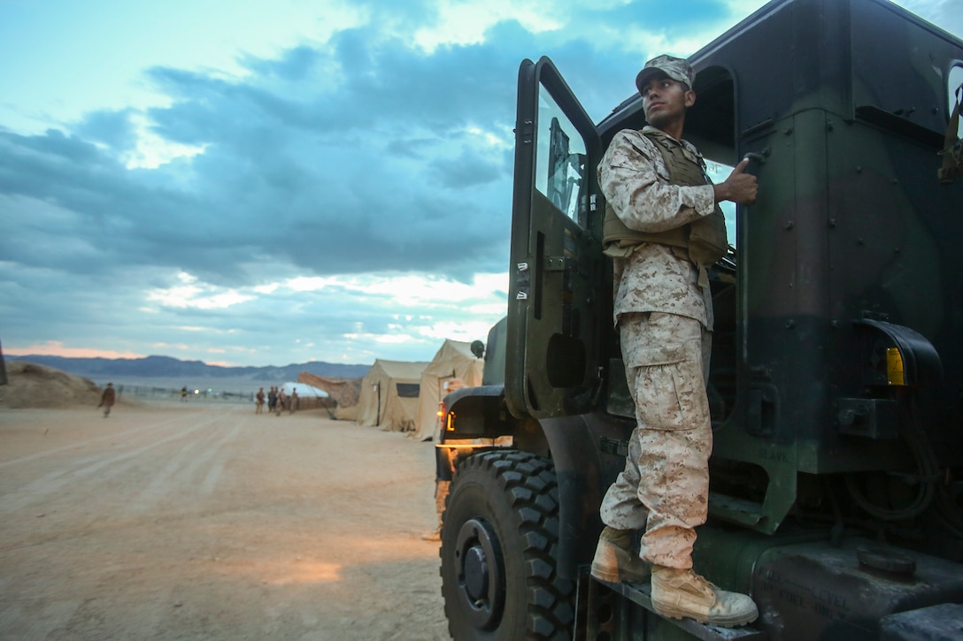 Sergeant Luis Palomar, a motor transportation operator with 1st Brigade Headquarters Group, 1st Marine Expeditionary Brigade, from Escondido, California, prepares to mount a 7-ton Medium Tactical Vehicle prior to leaving on the first of two convoys from Marine Corps Air Ground Combat Center Twentynine Palms to Marine Corps Base Camp Pendleton, California, Aug. 12, 2014. 1st MEB Marines started tearing down Camp Francis and transported the gear as Large Scale Exercise 2014 comes to an end. LSE-14 is a bilateral training exercise conducted by 1st MEB to build U.S. and Canadian forces’ joint capabilities through live, simulated, and constructive military training activities from Aug. 8-14.