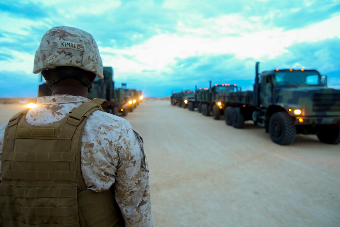 Staff Sgt. Qwan Kimble, a motor transportation operations chief with 1st Brigade Headquarters Group, 1st Marine Expeditionary Brigade, from Saint Martin, Louisiana, prepares to give the command to his drivers to depart on the first of two convoys from Marine Corps Air Ground Combat Center Twentynine Palms to Marine Corps Base Camp Pendleton, Calififornia, Aug. 12, 2014. 1st MEB Marines started tearing down Camp Francis and transported the gear as Large Scale Exercise 2014 comes to an end. LSE-14 is a bilateral training exercise conducted by 1st MEB to build U.S. and Canadian forces’ joint capabilities through live, simulated, and constructive military training activities from Aug. 8-14. 