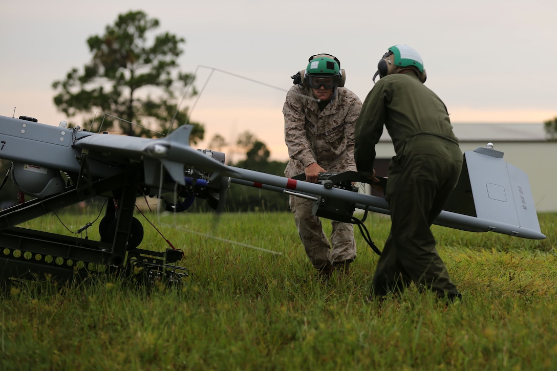 Lance Cpl. John M. Johnson Jr., left, and Lance Cpl. Jaleel Porter start the engine of a RQ-7B Shadow unmanned aerial vehicle during night flight training at Avon Park Air Force Range, Florida, Aug. 4, 2014. Both Johnson and Porter are unmanned aerial system maintainers with Marine Unmanned Aerial Vehicle Squadron 2. Johnson is a native of Yuma, Arizona, and Porter is a Oakland, California, native.