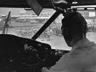 C-119 31 Jan 1961 - 19 Dec 1962; Formation Scene with Original Hanger in Background and taken from Cockpit of C-119; Person in Right Seat Unk (Photo by NCANG Heritage Program)